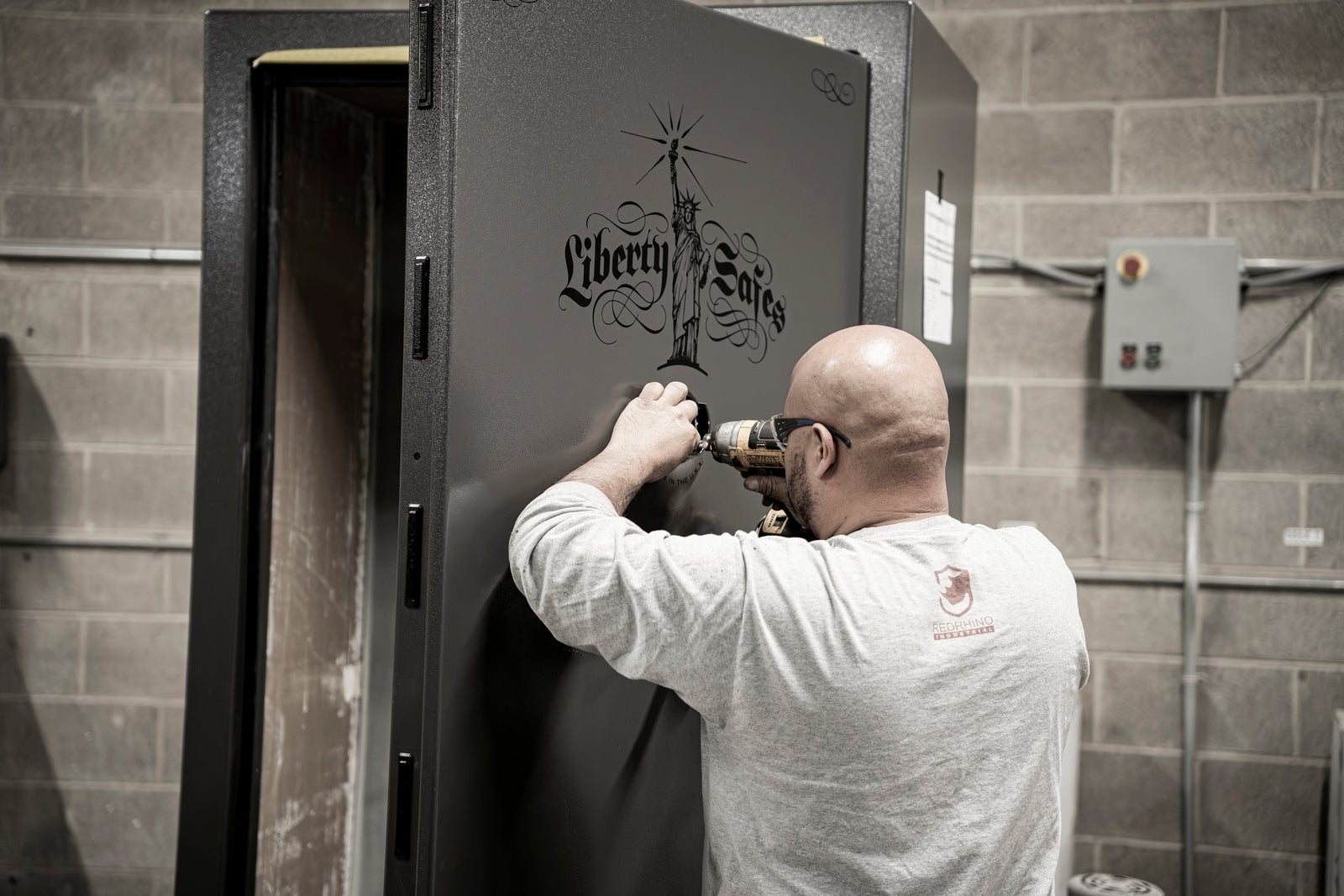 Technician installing a lock on a Liberty Safe gun safe